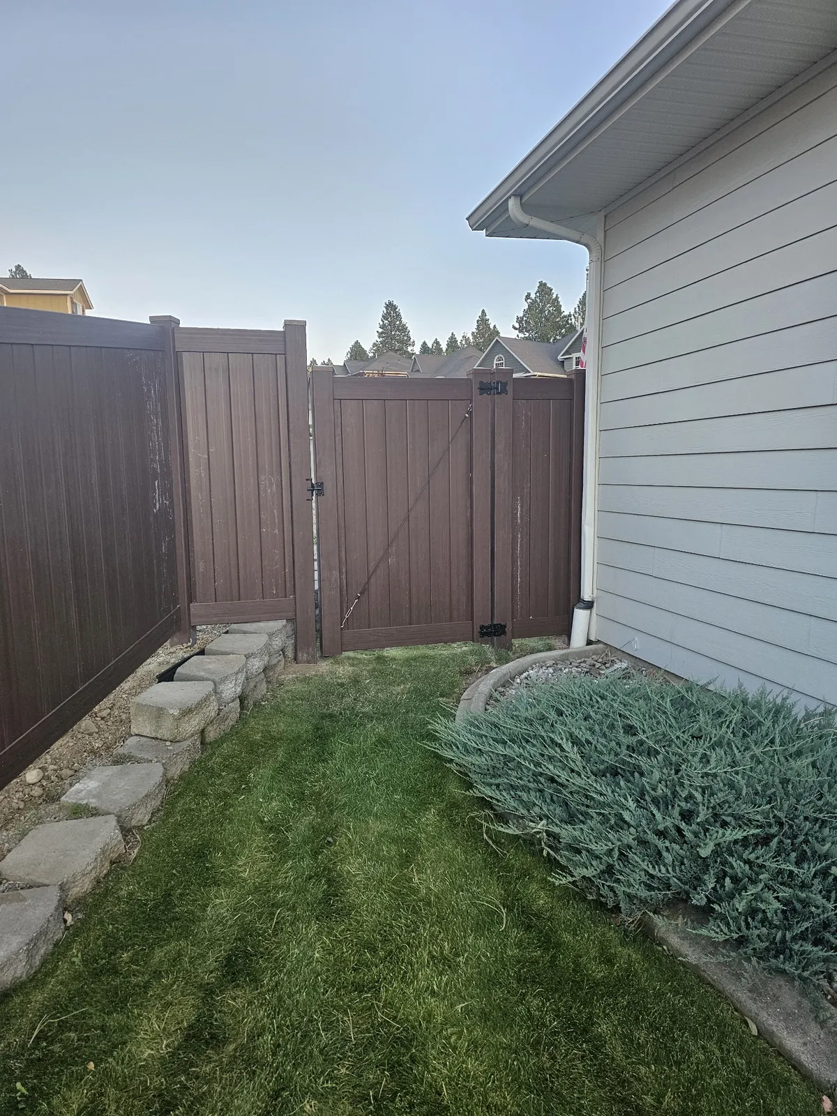 Striking Dark Wood Grain Vinyl Privacy Fence in Spokane, WA